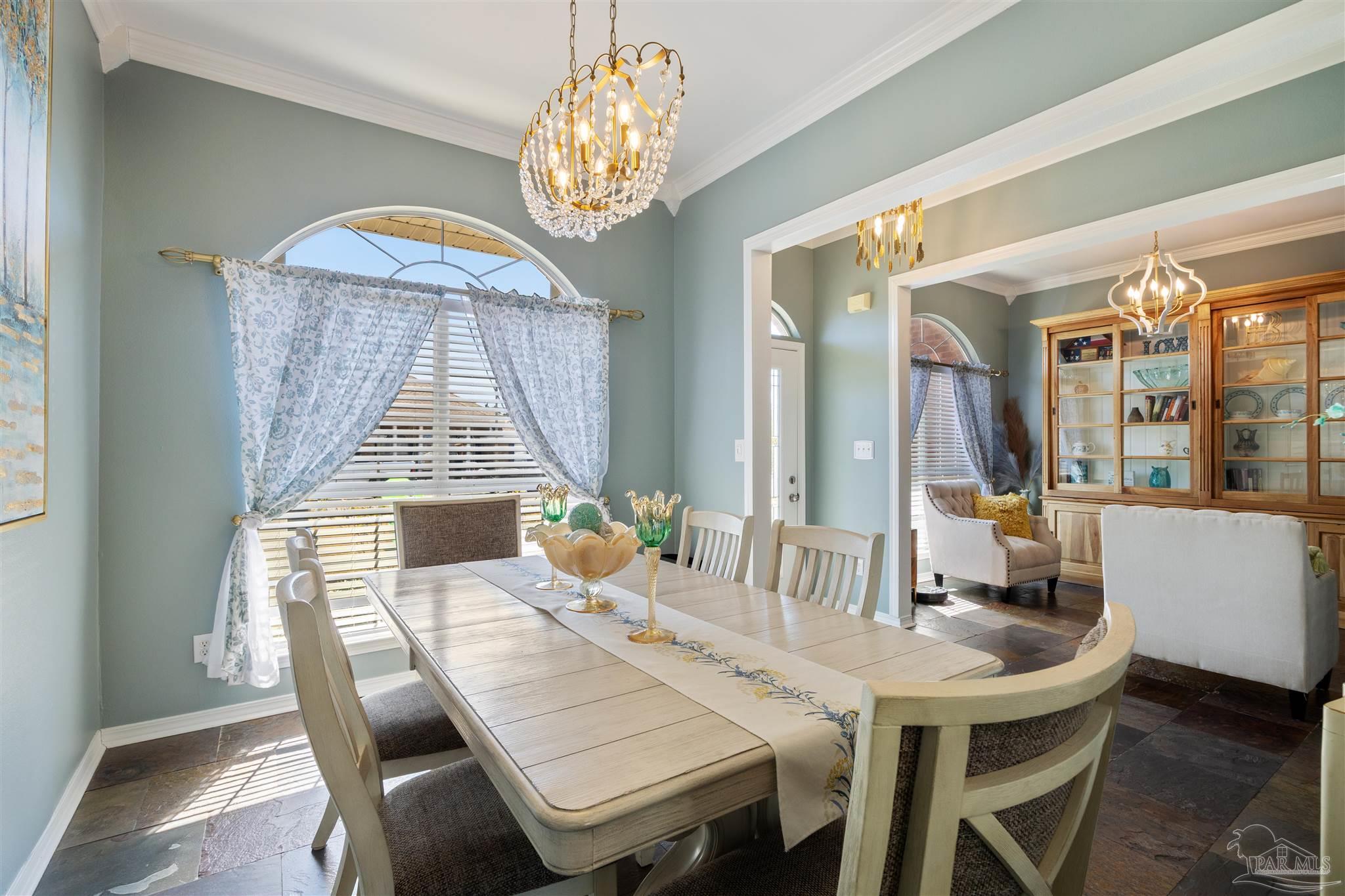 420 Collinwood Loop Foley, AL 36535 - Photo 15 of 63 a dining room with wooden floor a chandelier a wooden table and chairs