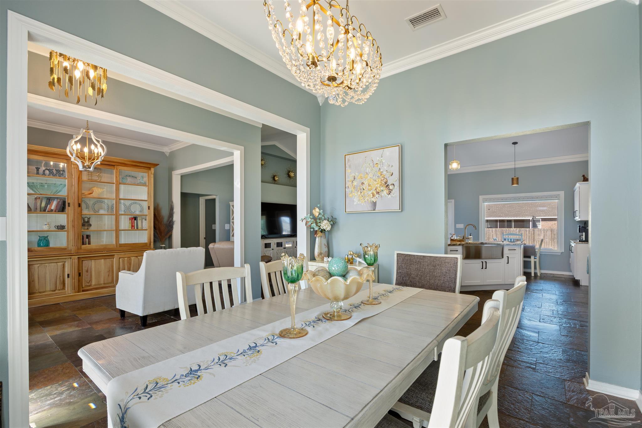 420 Collinwood Loop Foley, AL 36535 - Photo 16 of 63 a view of a dining room with furniture wooden floor and chandelier