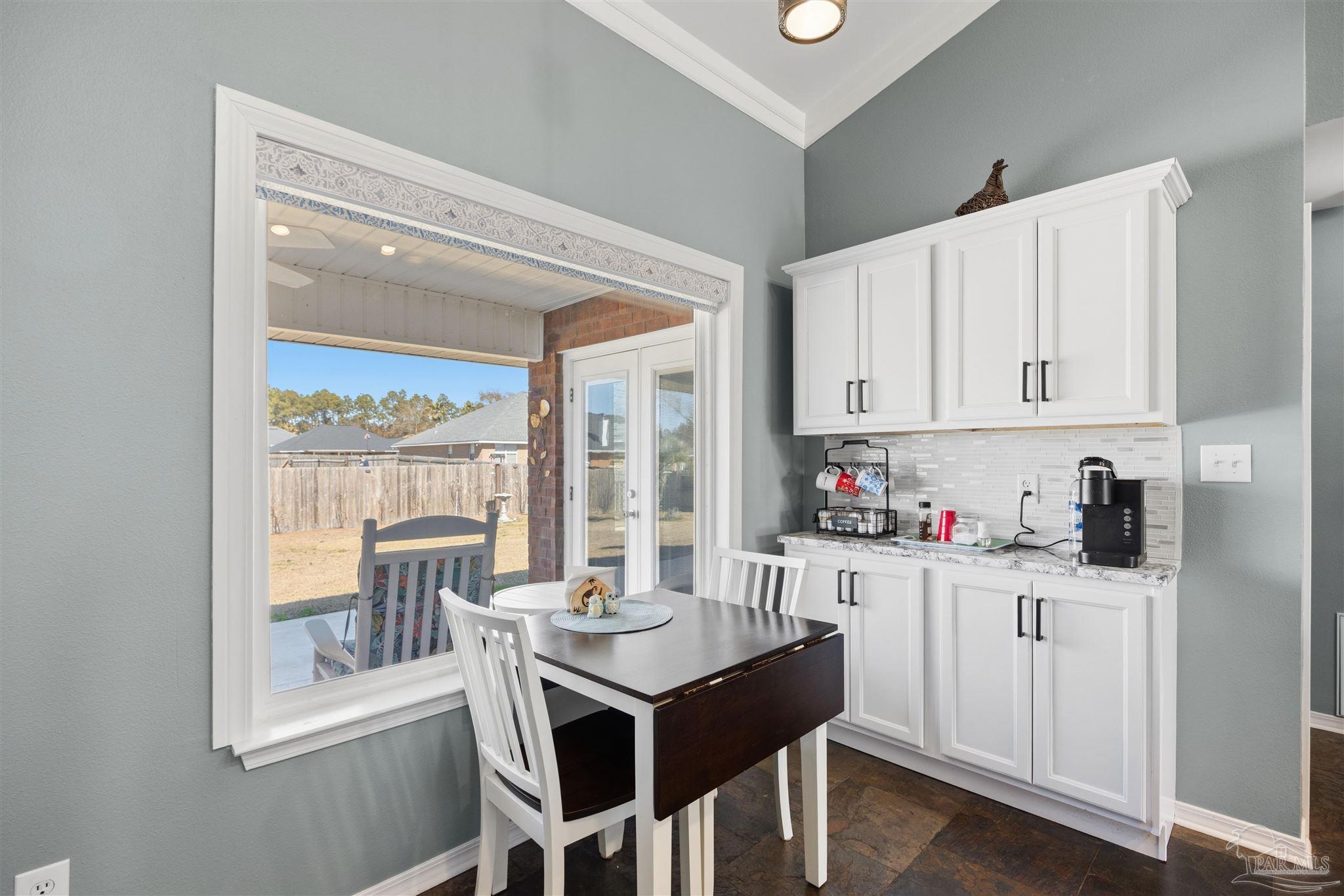 420 Collinwood Loop Foley, AL 36535 - Photo 21 of 63 a kitchen with granite countertop a stove a sink and white cabinets with wooden floors