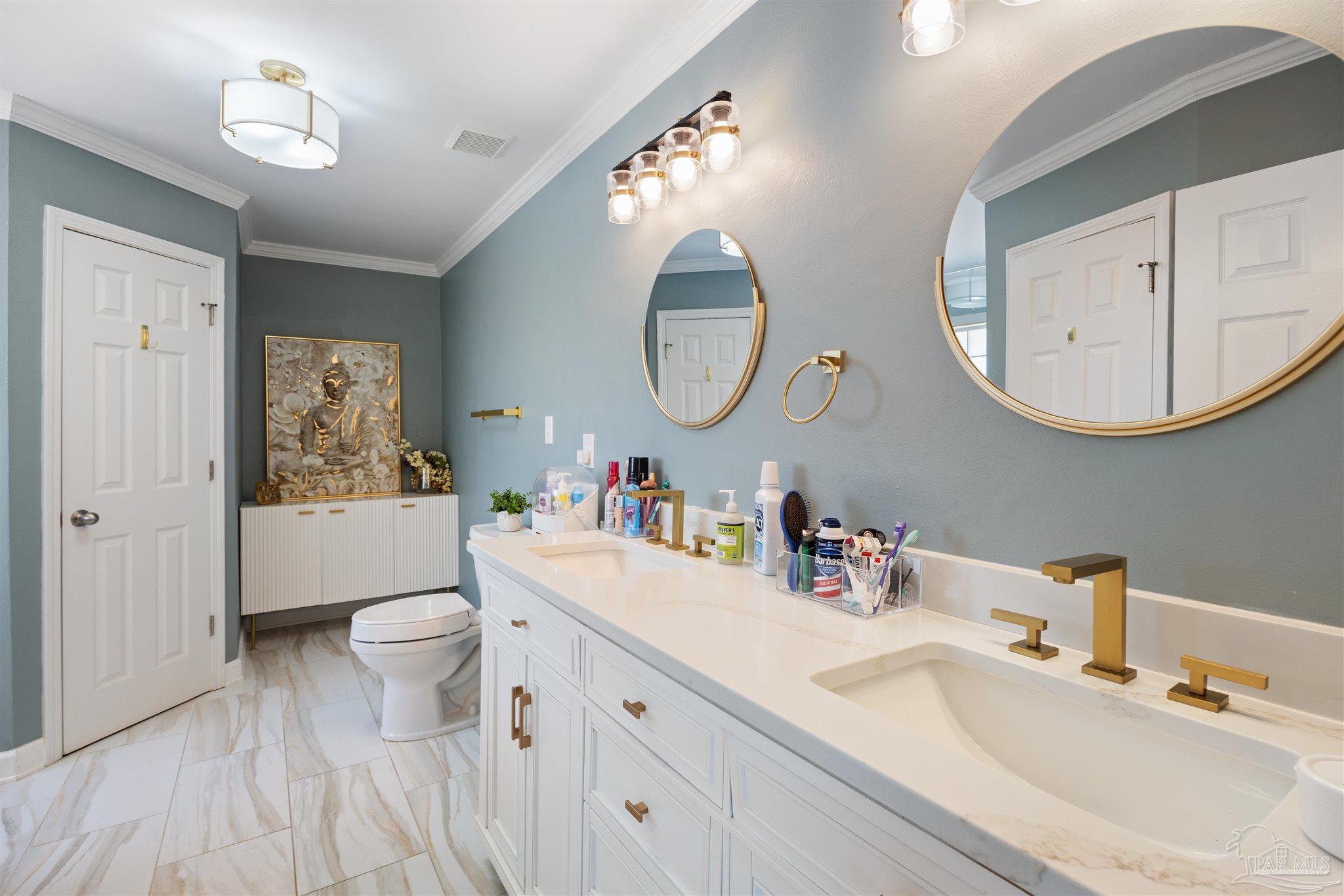 420 Collinwood Loop Foley, AL 36535 - Photo 25 of 63 a bathroom with a toilet a sink a mirror and a lamp