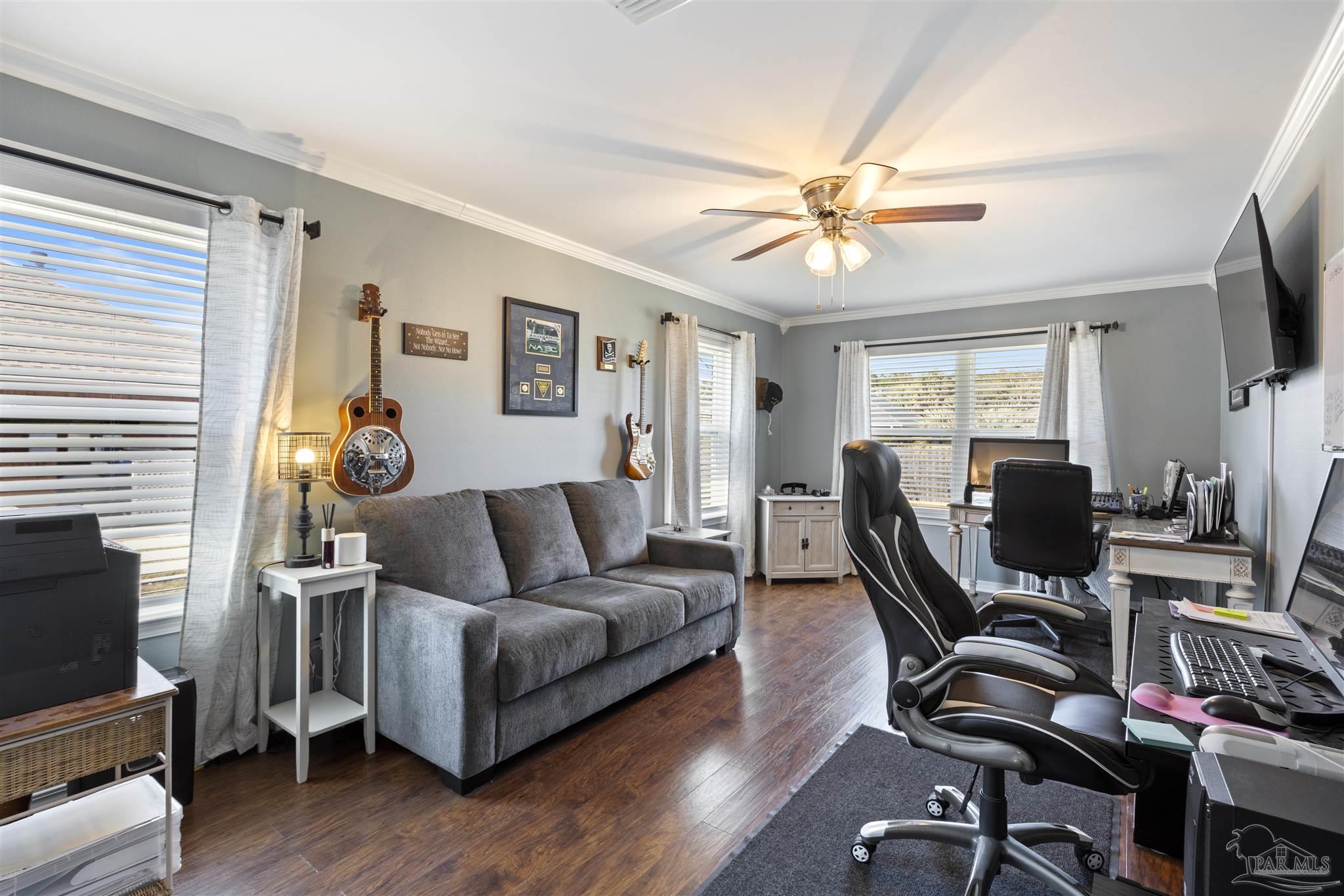 420 Collinwood Loop Foley, AL 36535 - Photo 4 of 63 a living room with furniture a flat screen tv and a window
