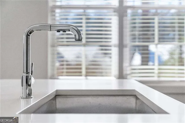 a kitchen that has a sink and a stove