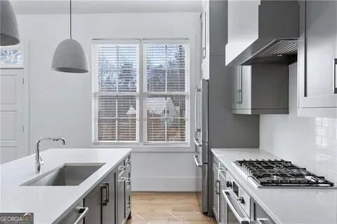 a kitchen with granite countertop a sink and a fireplace