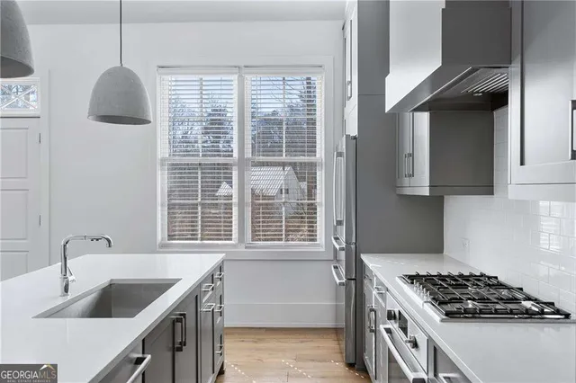 a kitchen with granite countertop a sink and a fireplace