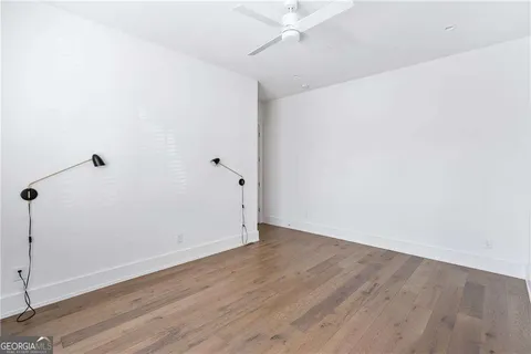 an empty room with wooden floor and door