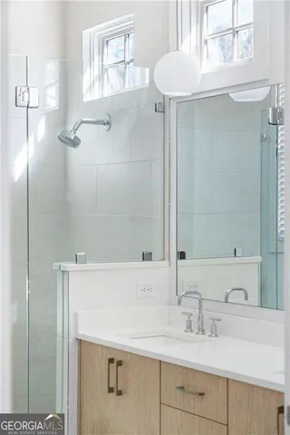 a bathroom with a double vanity sink mirror and shower