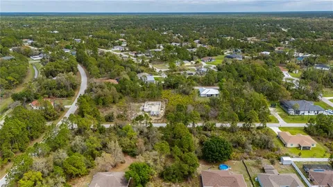 a view of a green field with lots of bushes