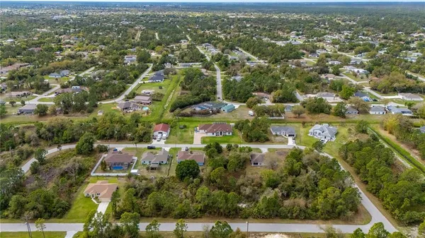 an aerial view of residential building with green space