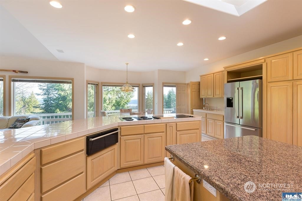 485 Doe Run Road Sequim, WA 98382 - Photo 20 of 40 a kitchen with a sink stove and cabinets