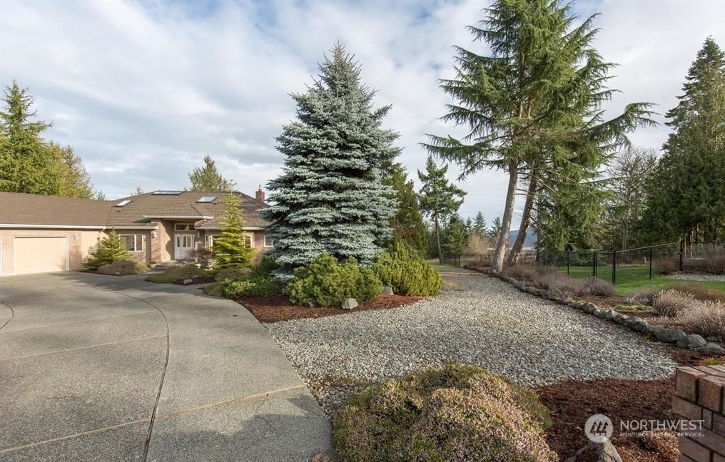 485 Doe Run Road Sequim, WA 98382 - Photo 2 of 40 a view of a yard with plants and trees