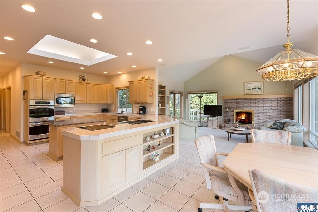 485 Doe Run Road Sequim, WA 98382 - Photo 21 of 40 a kitchen with a stove cabinets and chairs