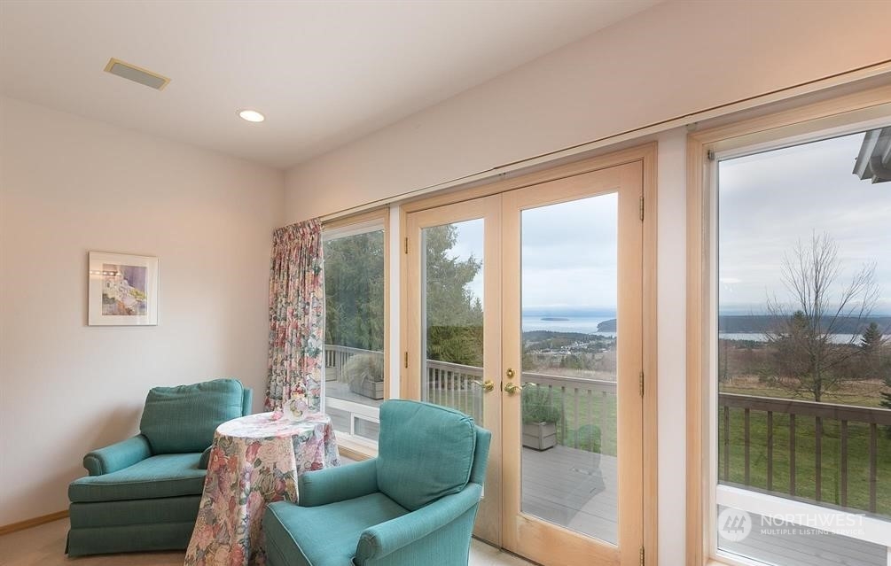 485 Doe Run Road Sequim, WA 98382 - Photo 27 of 40 a living room with furniture and a floor to ceiling window