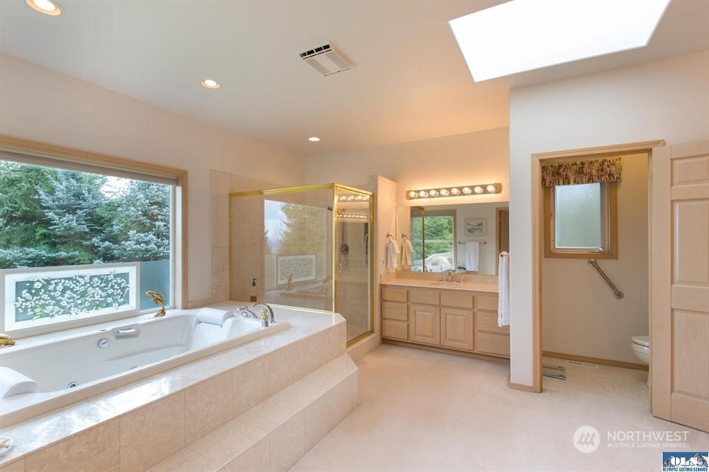 485 Doe Run Road Sequim, WA 98382 - Photo 28 of 40 a bathroom with a tub sink shower and mirror