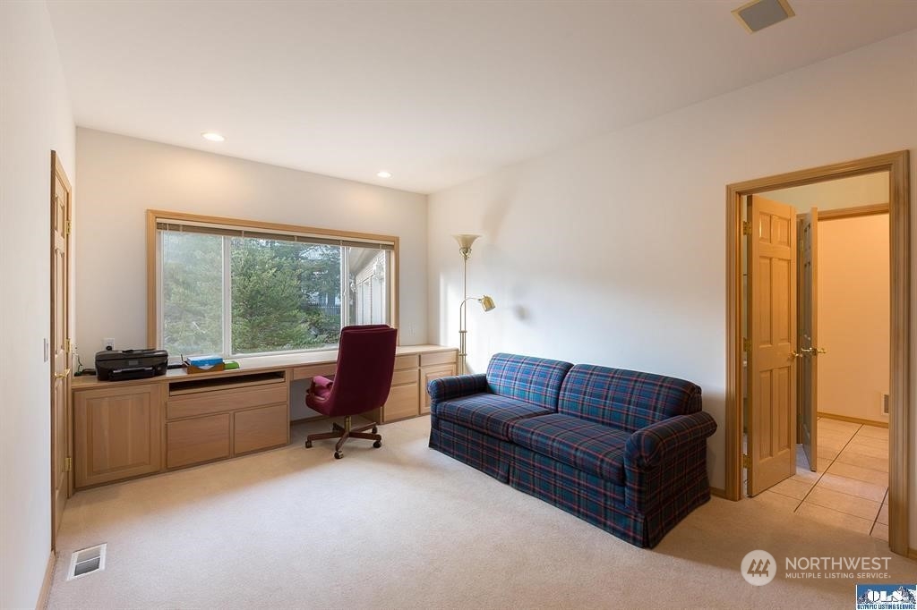 485 Doe Run Road Sequim, WA 98382 - Photo 33 of 40 a living room with furniture flat screen tv and large windows