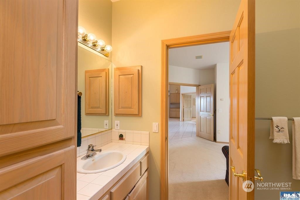 485 Doe Run Road Sequim, WA 98382 - Photo 34 of 40 a bathroom with a tub sink and mirror