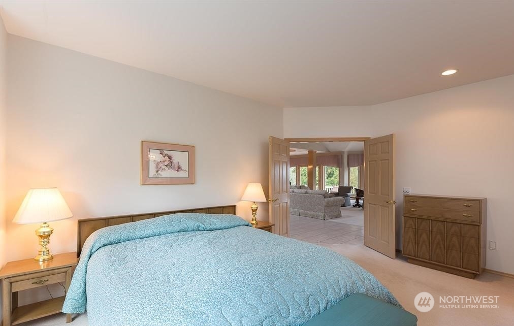 485 Doe Run Road Sequim, WA 98382 - Photo 36 of 40 a bedroom with a bed and dresser with mirror