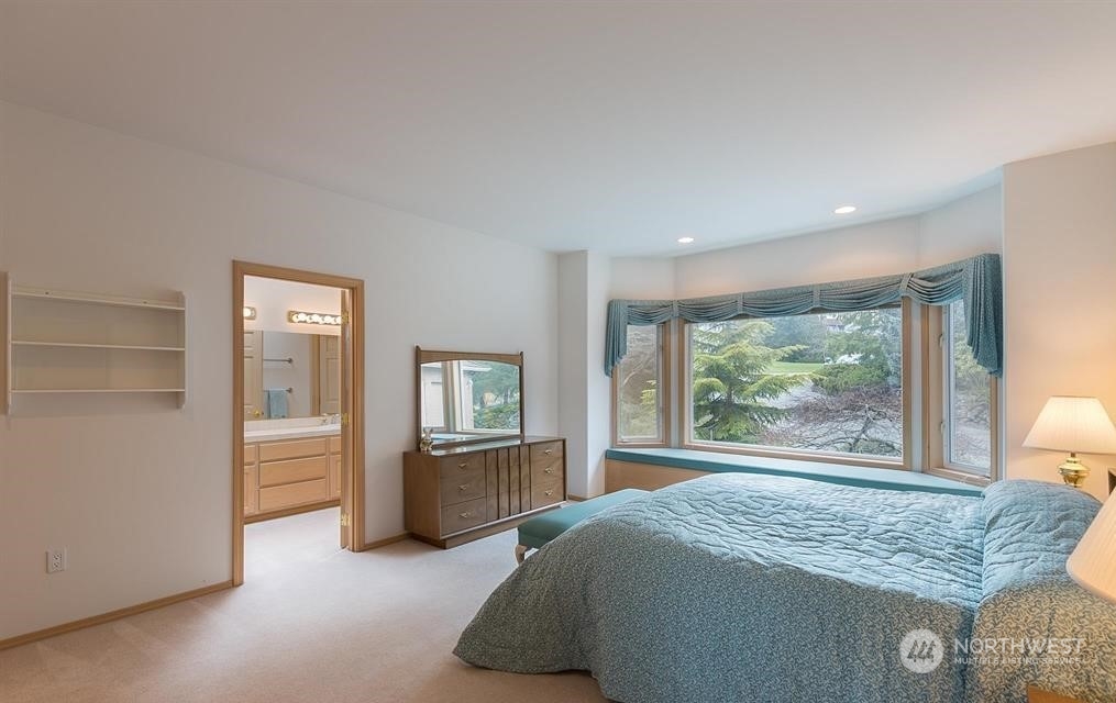 485 Doe Run Road Sequim, WA 98382 - Photo 37 of 40 a bed sitting in a spacious bedroom next to a window