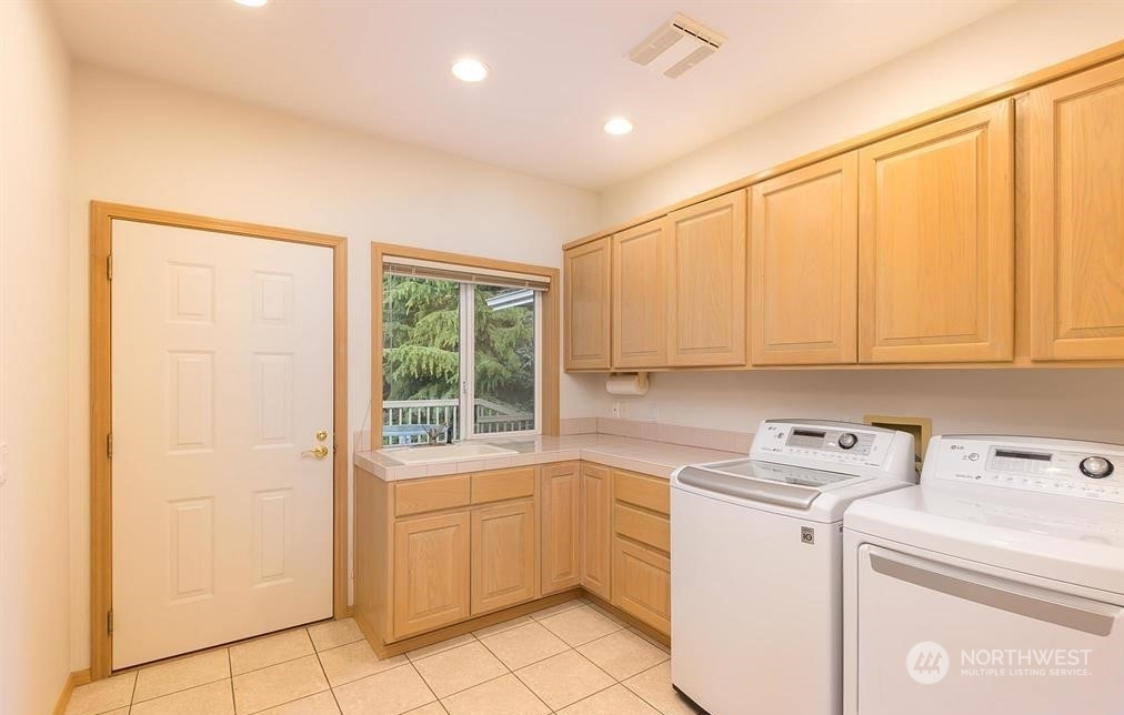 485 Doe Run Road Sequim, WA 98382 - Photo 39 of 40 a utility room with dryer and washer