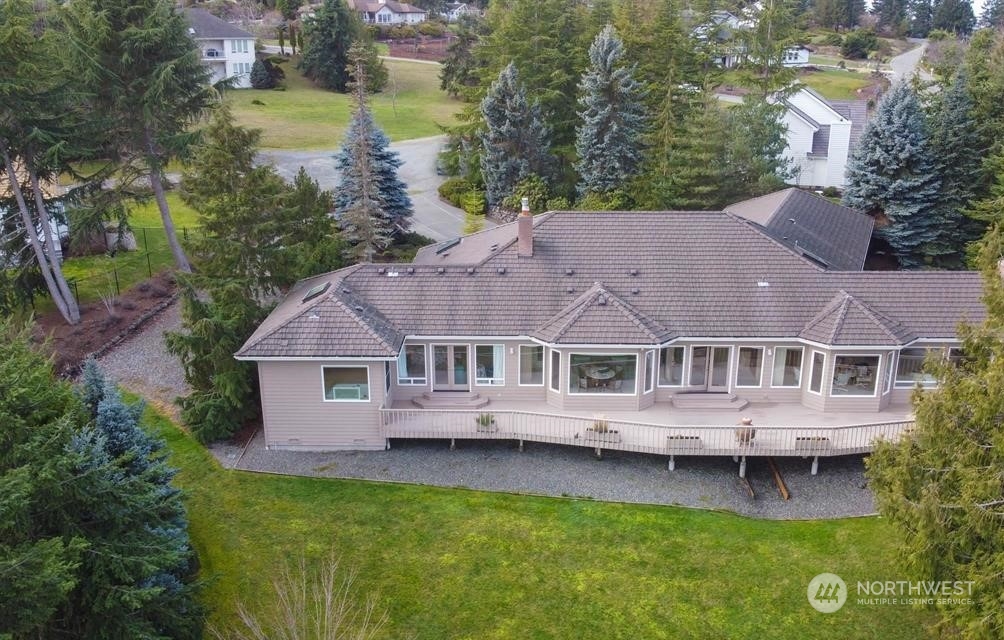 485 Doe Run Road Sequim, WA 98382 - Photo 5 of 40 a view of a house with a garden and a small yard