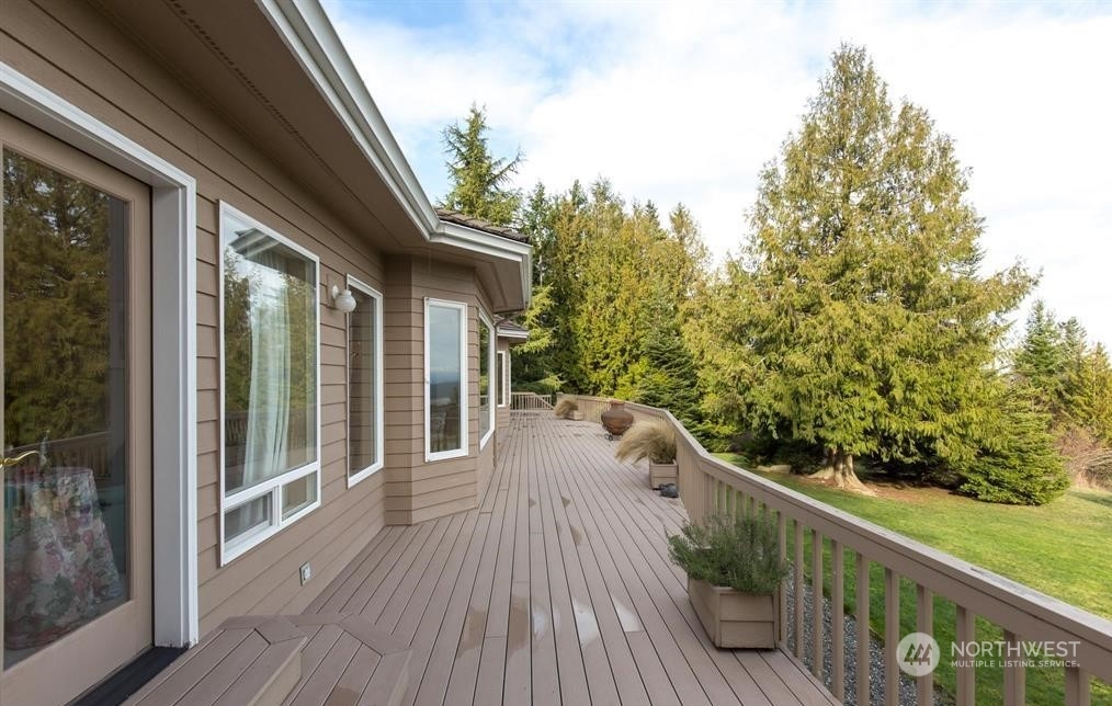 485 Doe Run Road Sequim, WA 98382 - Photo 10 of 40 a view of balcony with wooden floor and fence