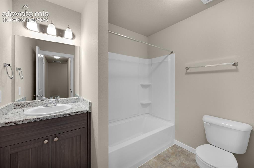 6644 Rawhide Rdg View Colorado Springs, CO 80915 - Photo 23 of 26 a bathroom with a granite countertop sink toilet and shower