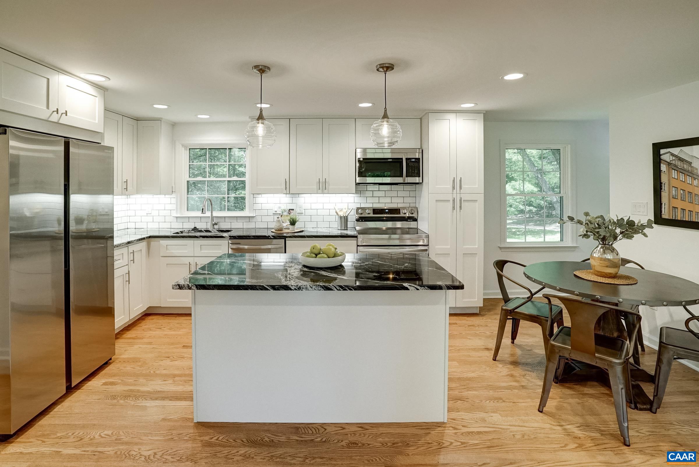 1038 Smith Road Afton, VA 22920 - Photo 13 of 49 a kitchen with stainless steel appliances kitchen island granite countertop a sink a stove a refrigerator a dining table and chairs