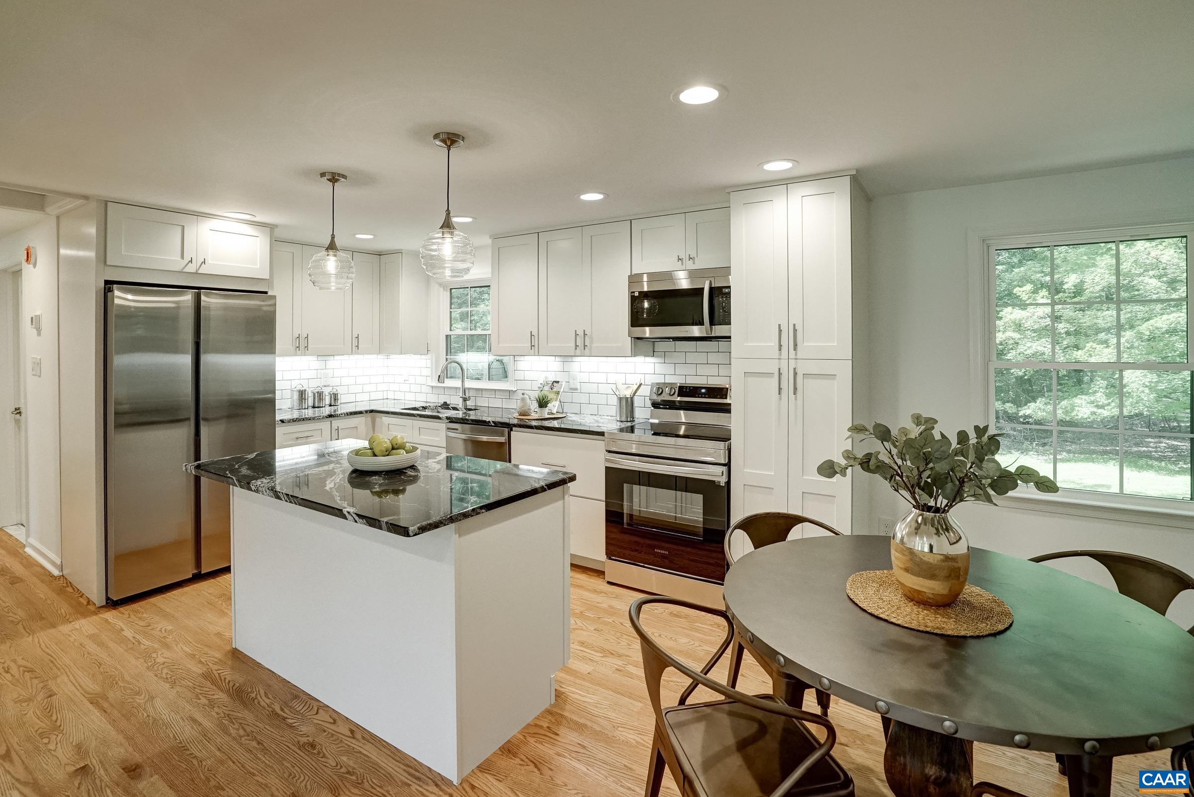 1038 Smith Road Afton, VA 22920 - Photo 14 of 49 a kitchen with kitchen island granite countertop a sink and stainless steel appliances