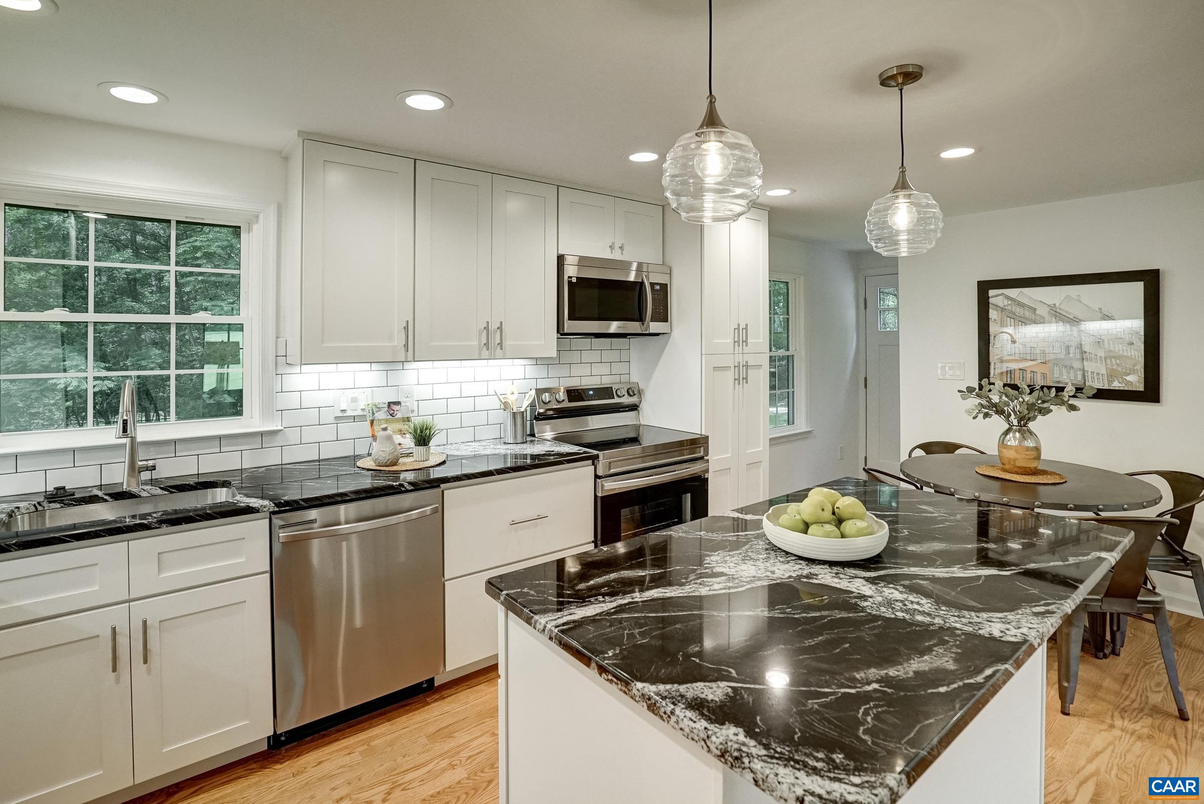 1038 Smith Road Afton, VA 22920 - Photo 16 of 49 a kitchen with a sink a stove and wooden floor