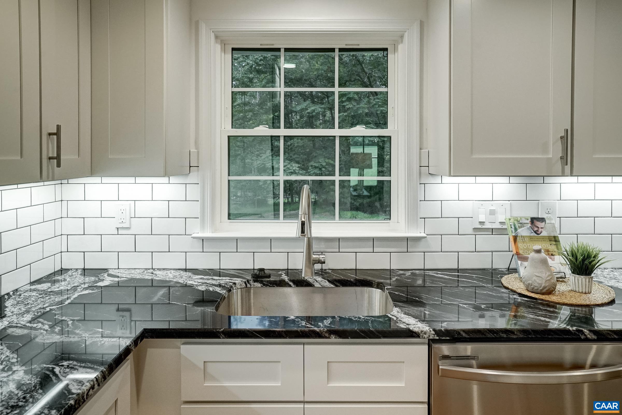 1038 Smith Road Afton, VA 22920 - Photo 17 of 49 a kitchen with granite countertop a sink and a white wooden cabinets