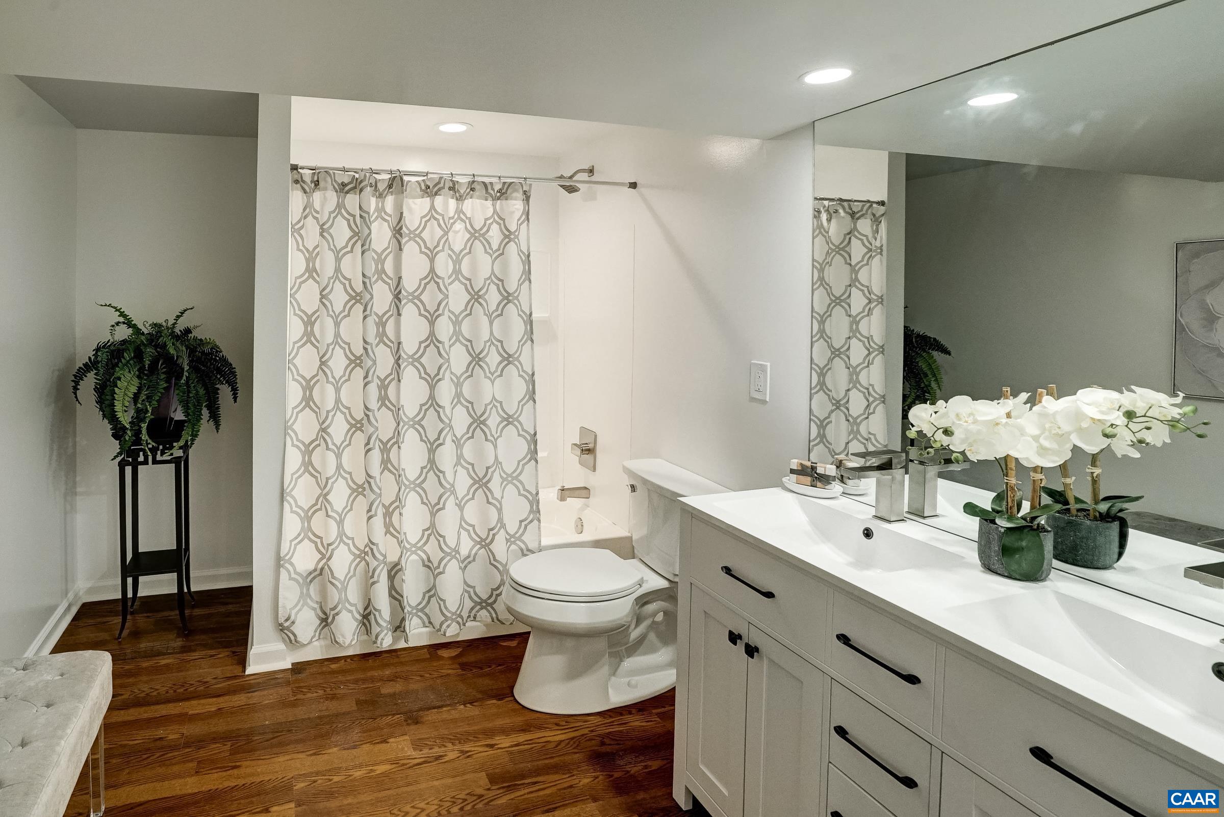 1038 Smith Road Afton, VA 22920 - Photo 32 of 49 a bathroom with a double vanity sink toilet and a mirror