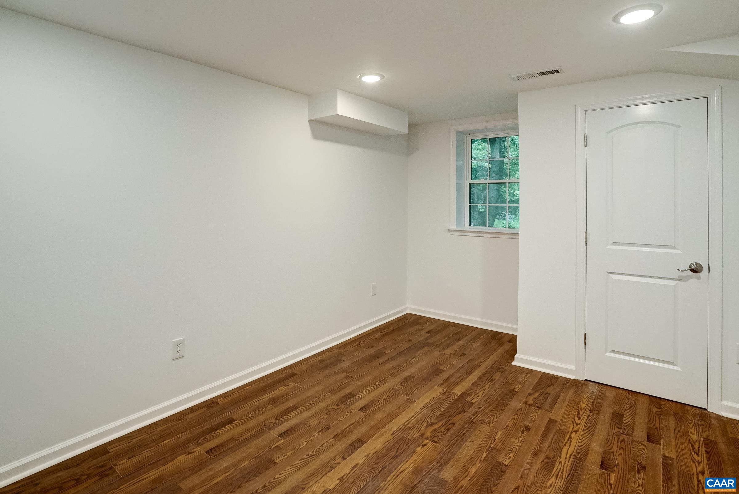 1038 Smith Road Afton, VA 22920 - Photo 34 of 49 a view of an empty room with wooden floor and a window