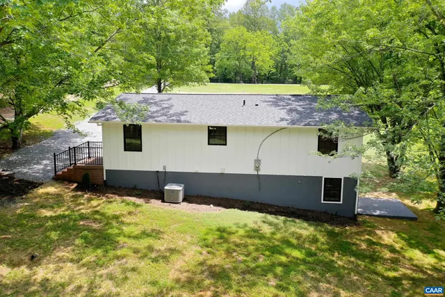 a backyard of a house with yard and tree