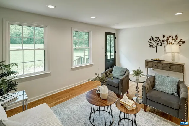 a living room with kitchen island furniture and wooden floor