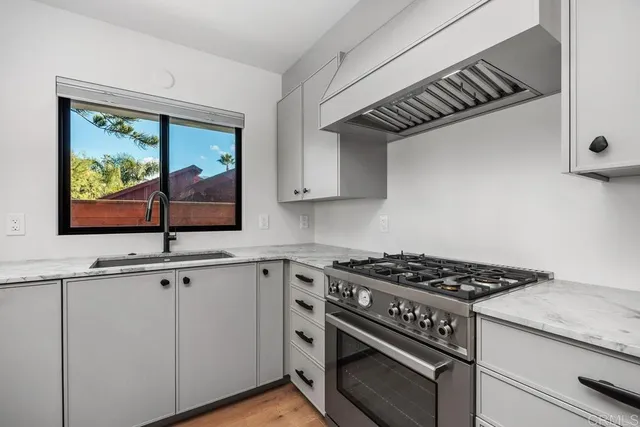 a kitchen with granite countertop a stove and a sink