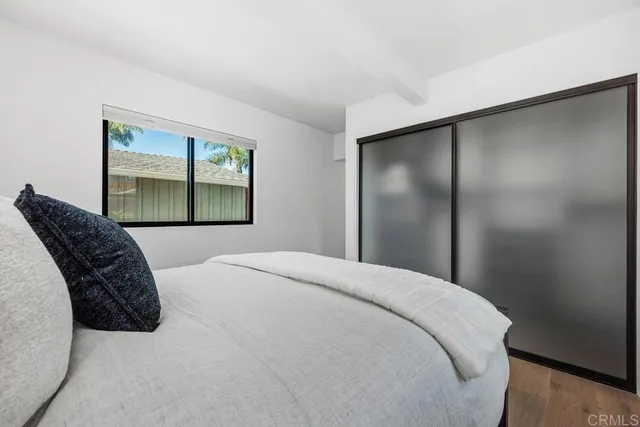 a bedroom with a large bed and a window