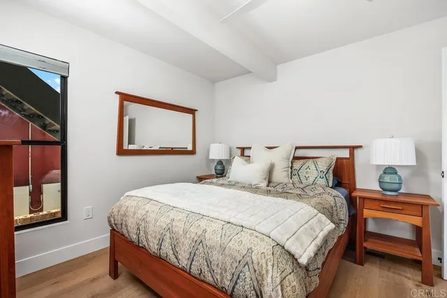 a bedroom with a bed and a night stand