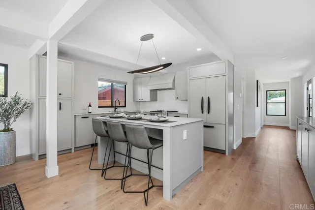 a kitchen with a sink cabinets and wooden floor