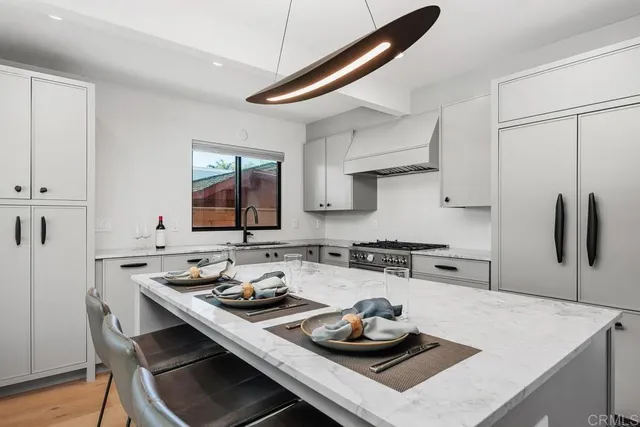 a kitchen with a stove a sink and a refrigerator