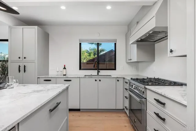 a kitchen with sink stove and cabinets
