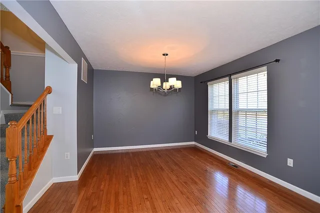 a view of a kitchen with granite countertop stainless steel appliances and wooden floor