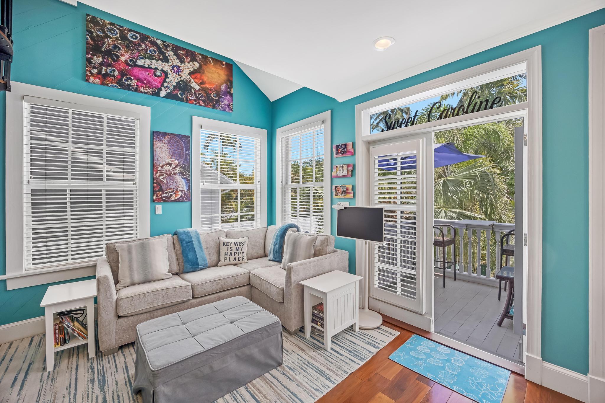 616 Caroline Street, Unit 5 Key West, FL 33040 - Photo 13 of 41 a living room with furniture and a large window with wooden floor
