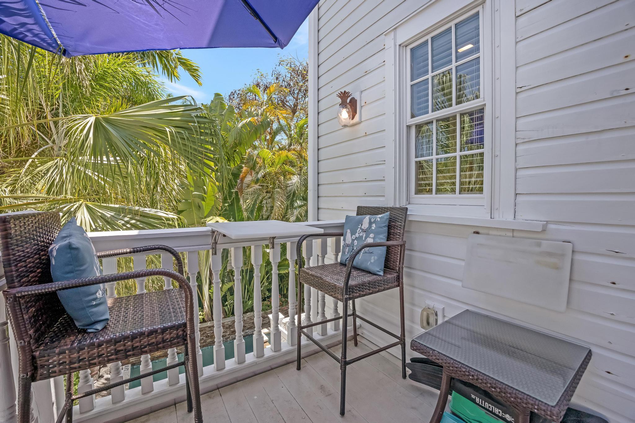 616 Caroline Street, Unit 5 Key West, FL 33040 - Photo 14 of 41 a view of a chairs and table in the balcony