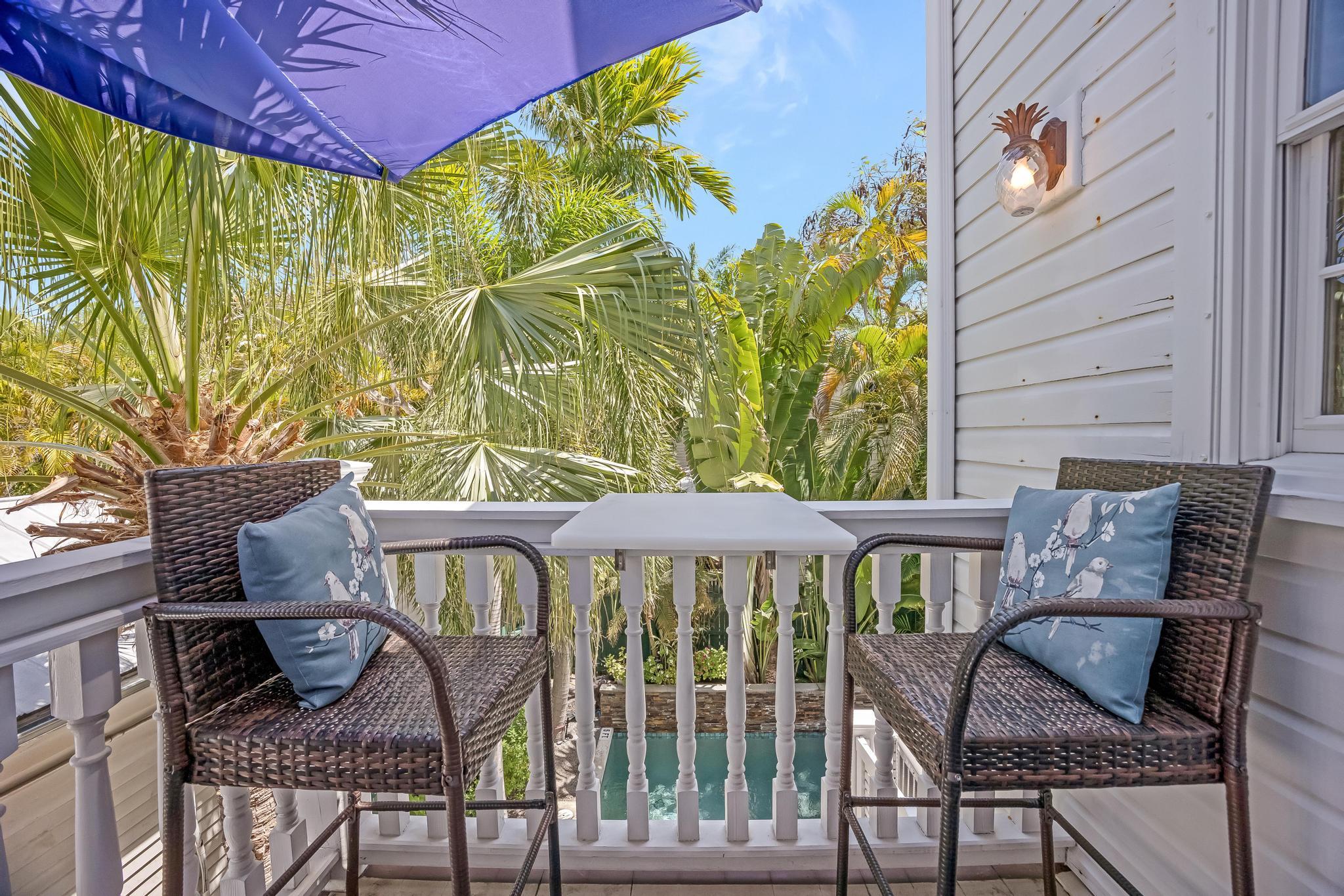 616 Caroline Street, Unit 5 Key West, FL 33040 - Photo 15 of 41 a front view of a house with table and chairs