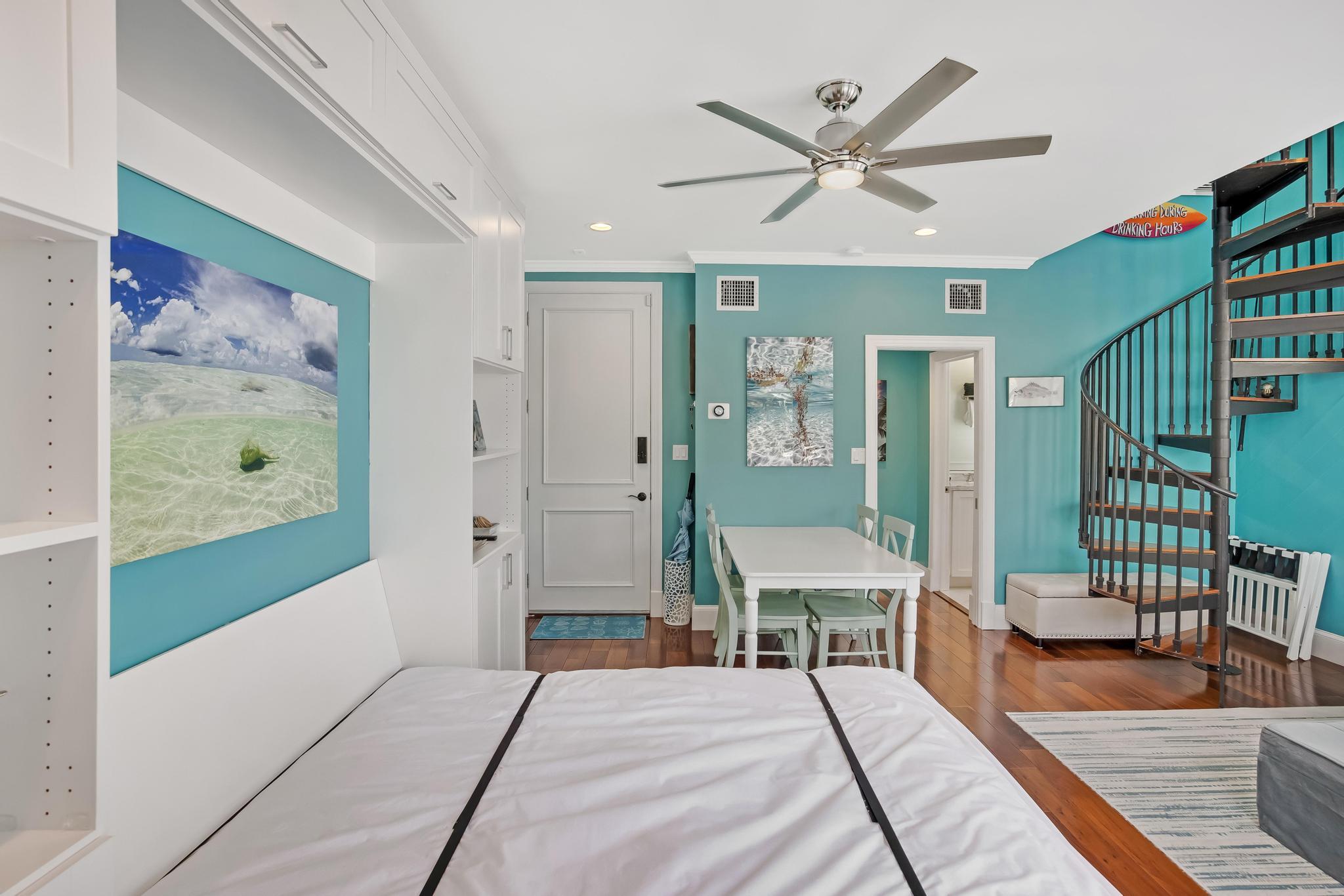 616 Caroline Street, Unit 5 Key West, FL 33040 - Photo 19 of 41 a spacious bedroom with a bed and a chandelier