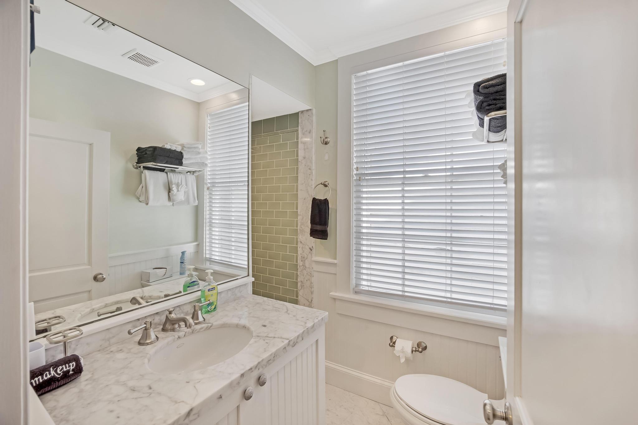 616 Caroline Street, Unit 5 Key West, FL 33040 - Photo 21 of 41 a bathroom with a granite countertop sink toilet a mirror and shower