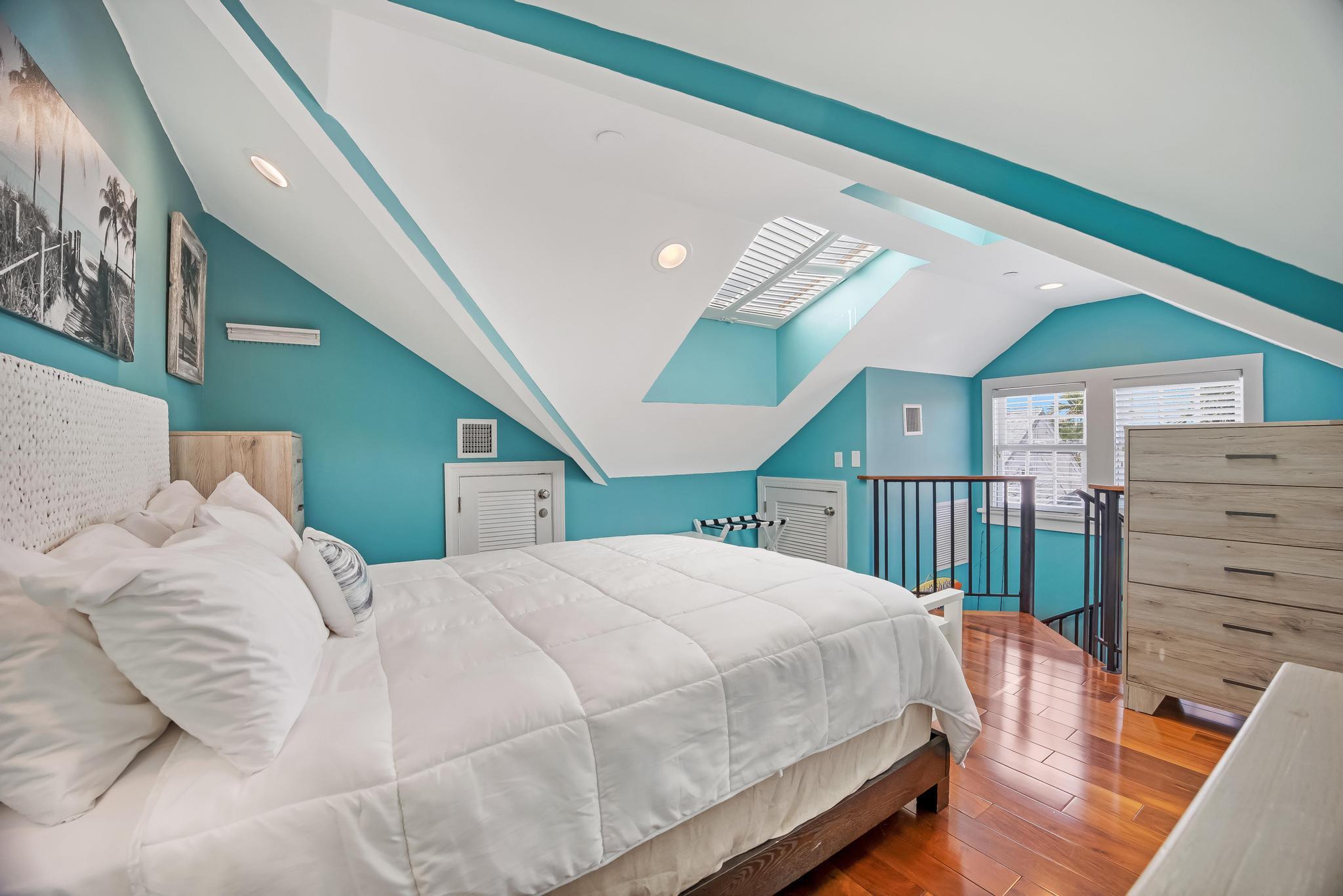 616 Caroline Street, Unit 5 Key West, FL 33040 - Photo 30 of 41 a bedroom with a large bed and a large window
