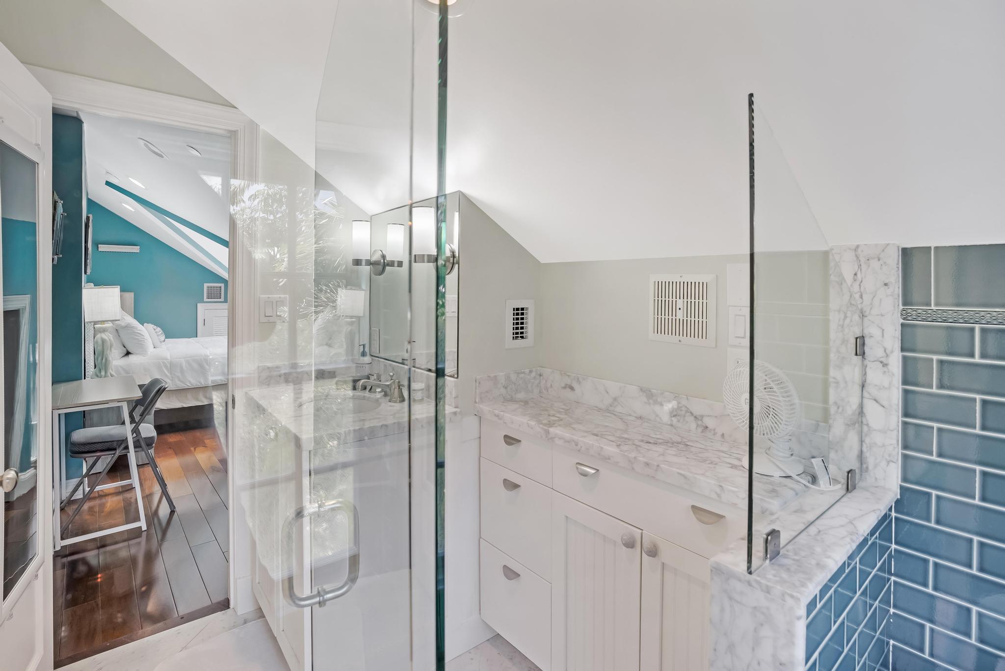 616 Caroline Street, Unit 5 Key West, FL 33040 - Photo 32 of 41 a bathroom with a glass shower door