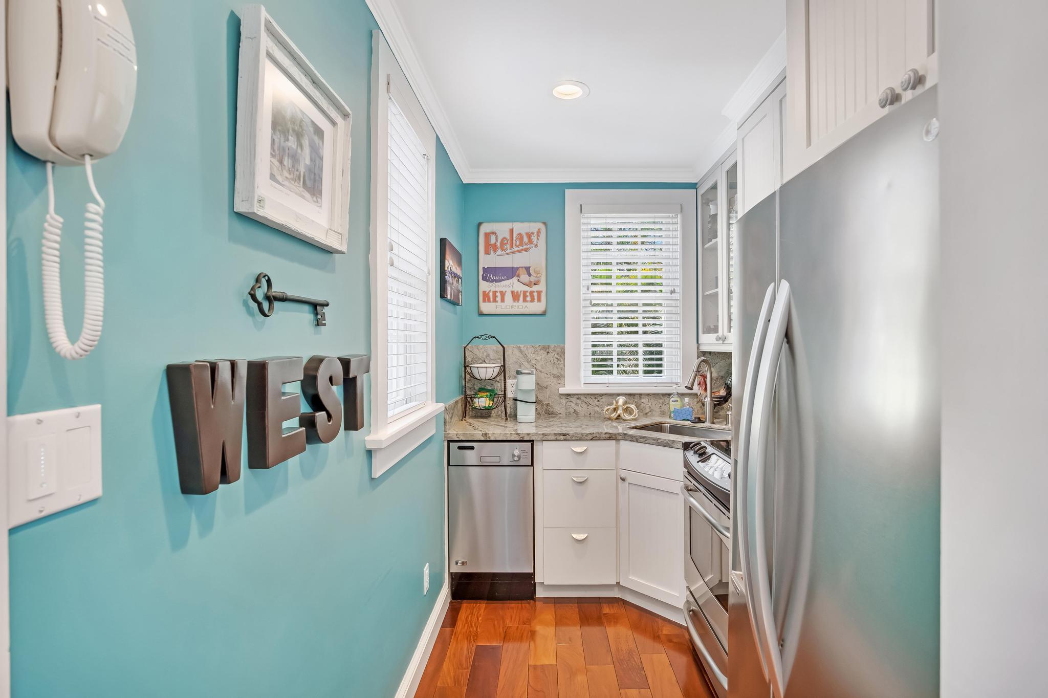 616 Caroline Street, Unit 5 Key West, FL 33040 - Photo 9 of 41 a kitchen with stainless steel appliances a sink a stove and a refrigerator