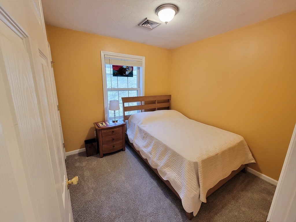 13 Oxbow Road Oxford, MA 01537 - Photo 14 of 31 a bed sitting in a bedroom next to a small bathroom