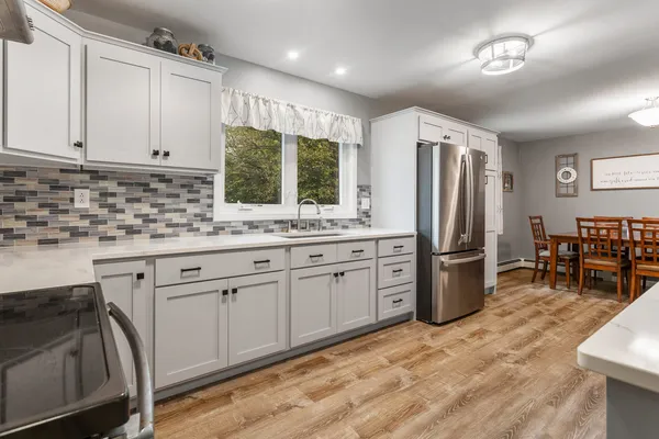 a kitchen with stainless steel appliances granite countertop a refrigerator sink and cabinets